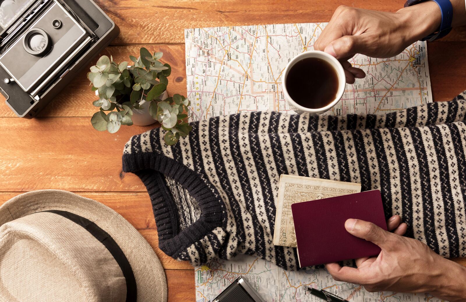 close up hands holding coffee passport