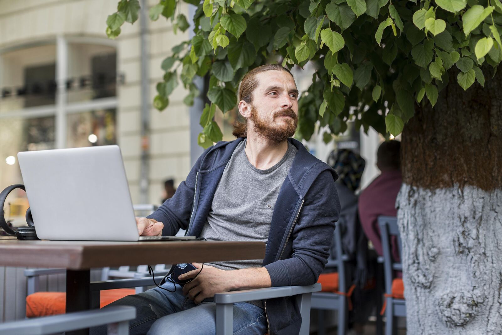 man with laptop city terrace